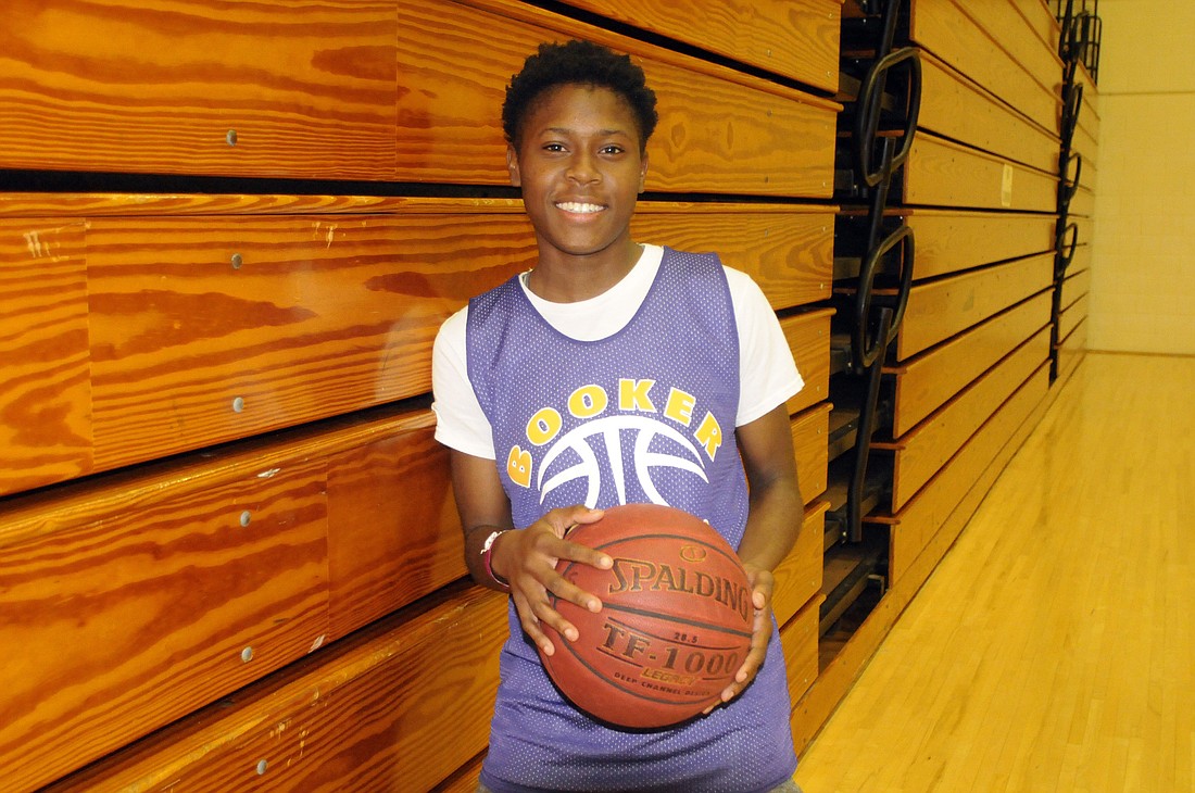 Booker High senior guard Senia Gibbons serves as both captain of the girls basketball team and Battalion Commander of the school's JROTC program.