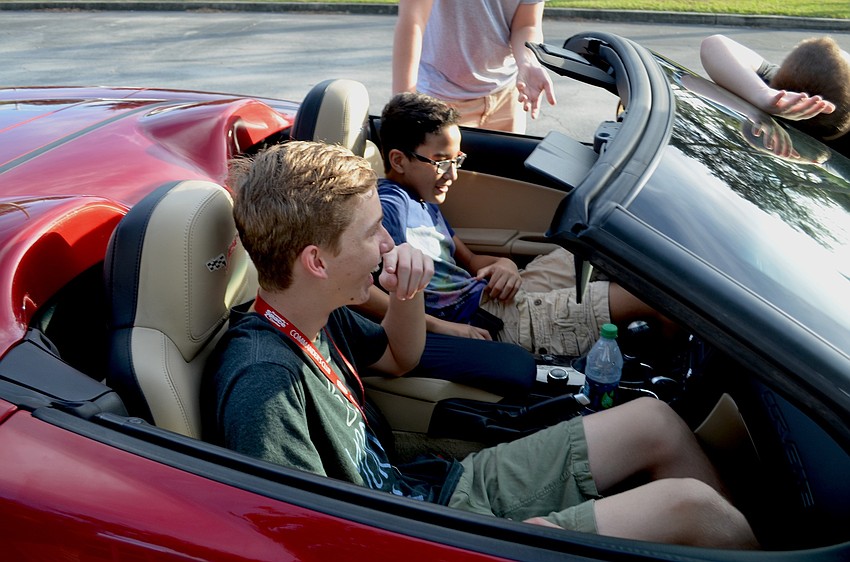 Eighth-graders Sam Martin and Braden Hameed enjoy time in a Corvette.