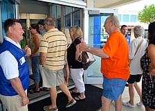 Goodwill employee Marion Motley greets the store's first customers with a smile.