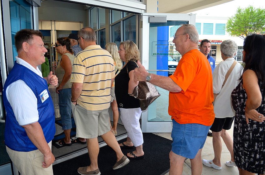 Goodwill employee Marion Motley greets the store's first customers with a smile.