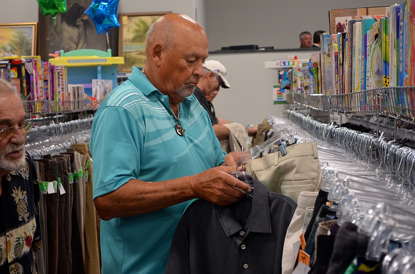 Dennis Kerl inspects a pair of khaki pants and a polo shirt.