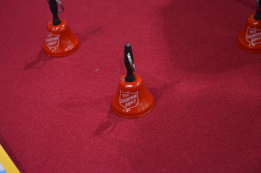 Miniature red bells that resemble the ones volunteers ring during the holiday season.