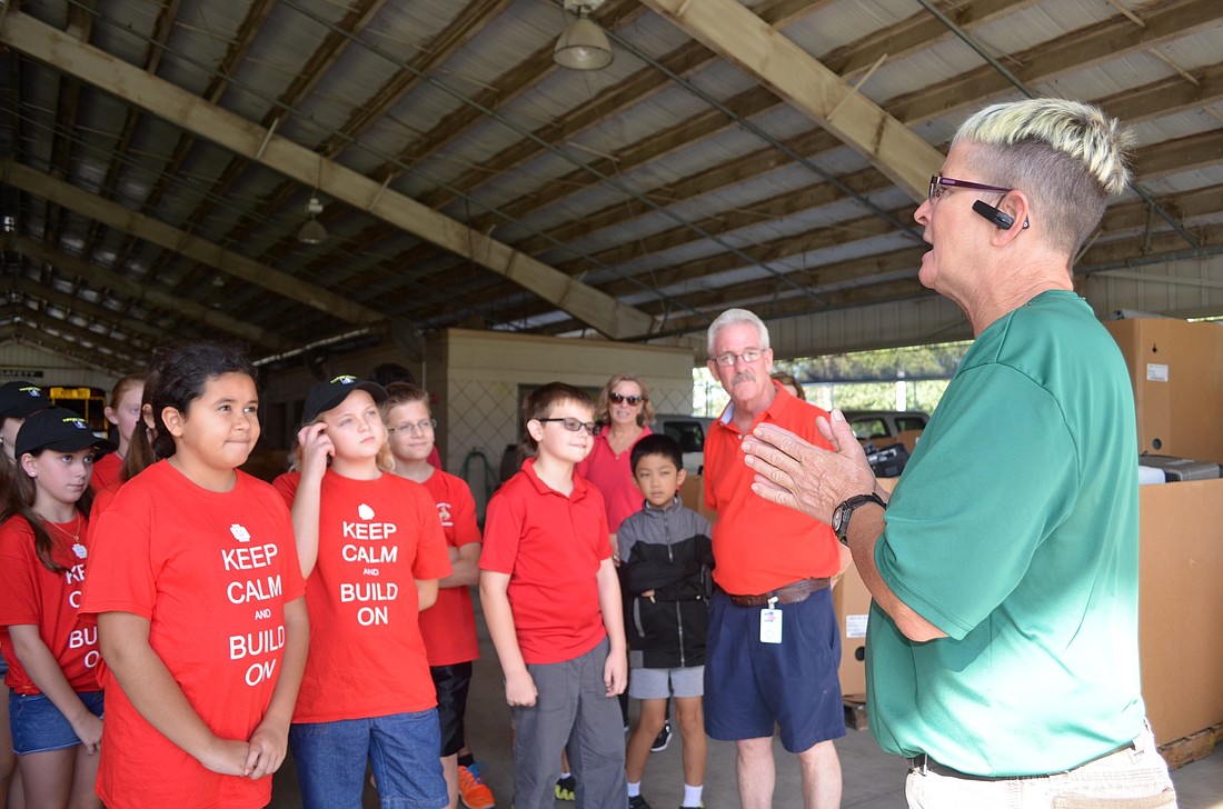 McNeal and Braden River elementary schools' students receive a lesson from Cari Walz, Household Hazardous Waste employee, on recycling electronics.