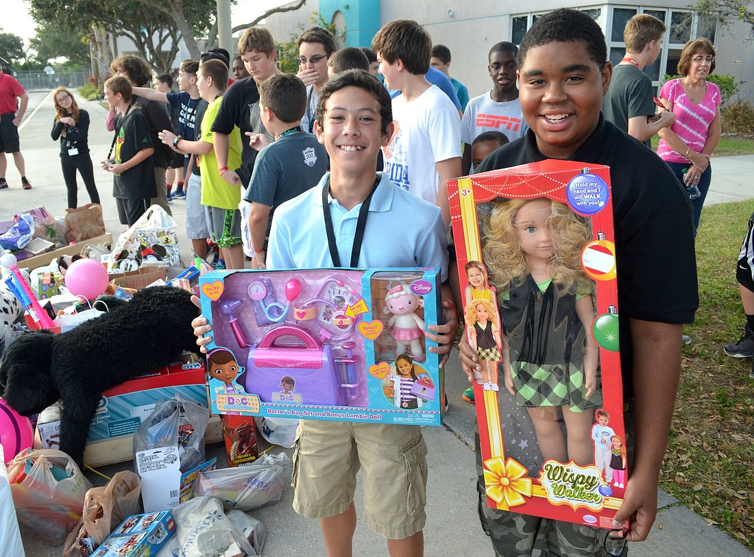 Derian Pettitt, 12, and Michael Haynes Jr., 14, donated dolls, among other toys.