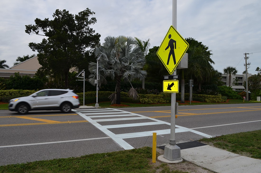 A Florida Department of Transportation crew finished striping the crosswalks on the road and made final adjustments to the lighting and push button activation systems this week.