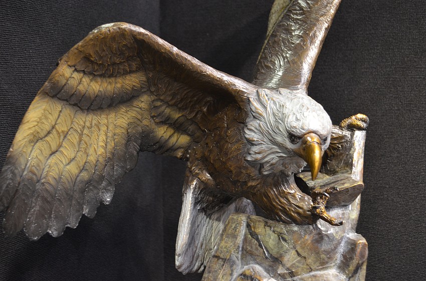 A lifelike wooden carving of an American Bald Eagle by Ben Foster.