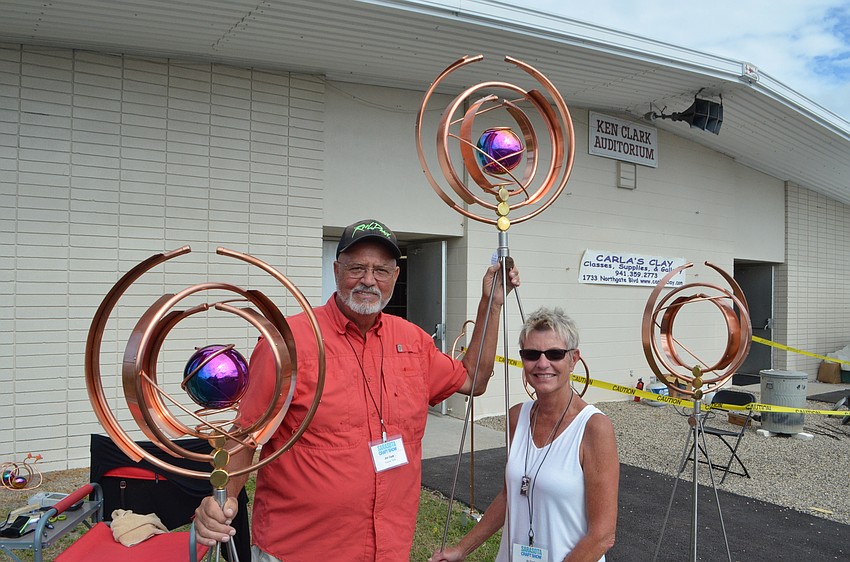 Jim and Jo Cook hanging outside Robarts Arena selling their colorful garden fixtures at the Sarasota Craft Show
