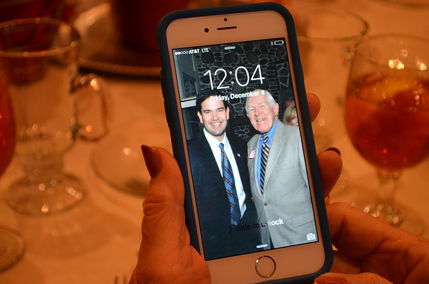 Judy Falkenthal shows off her phone background of Sen. Marco Rubio with Chuck Volkert.