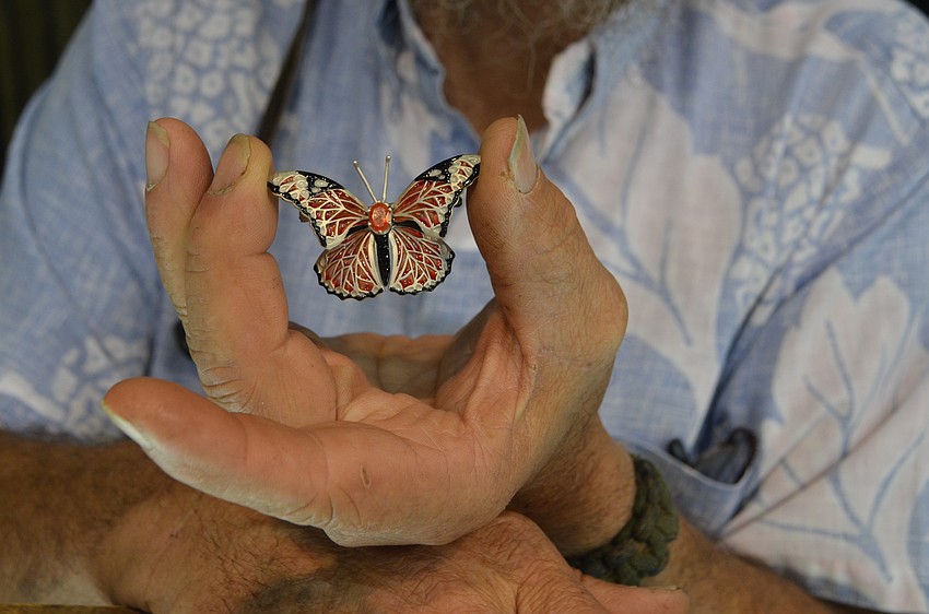 Carl Caristo shows off his intricate and detailed butterfly jewelry.