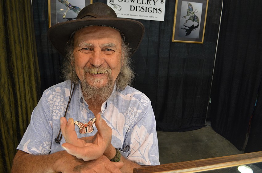 Carl Caristo shows off his intricate and detailed butterfly jewelry.