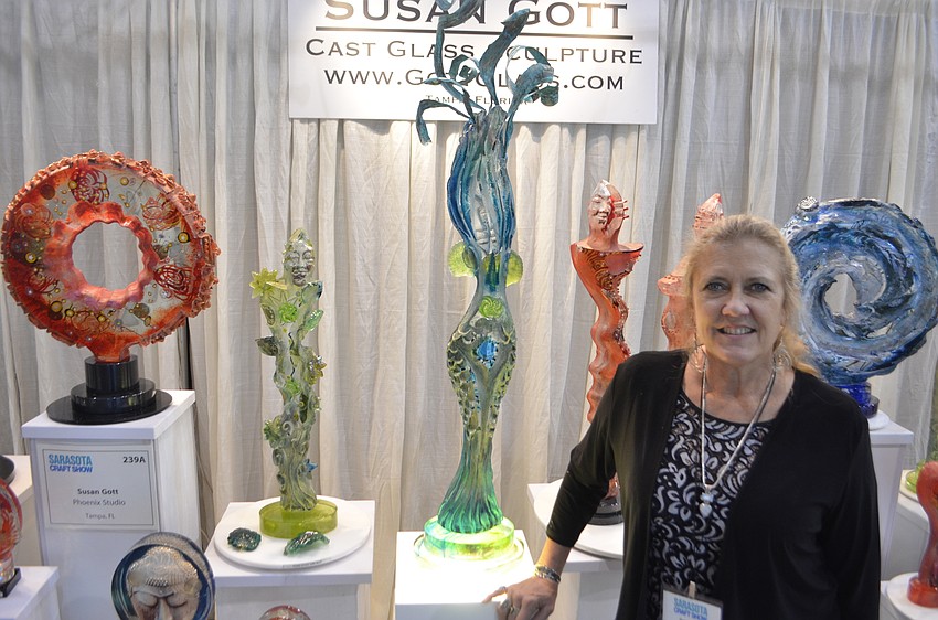 Susan Cott in front of her hand-made glass statuary.