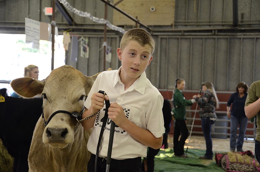 David Collica, with the Foxmill Kids 4-H Club, gets ready to go to the arena.