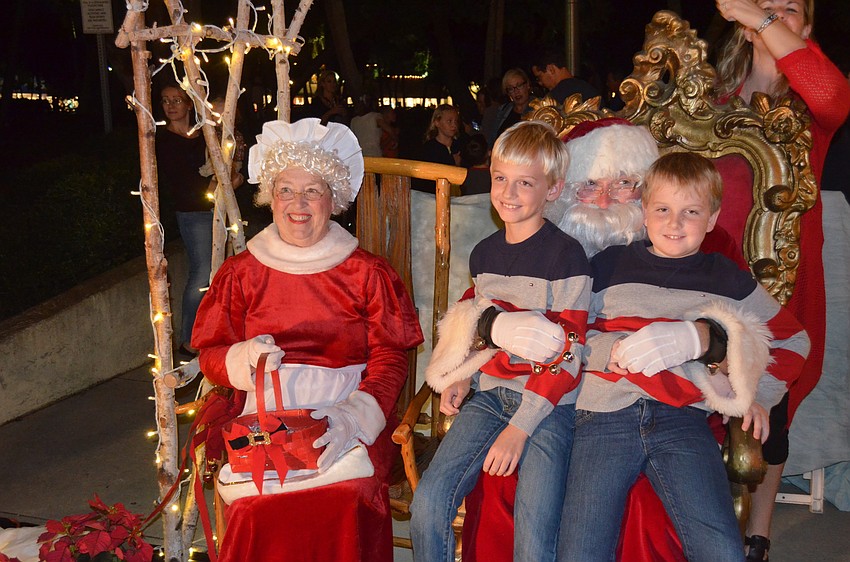 Evan Scott, 9, and brother, Ethan, 7, with Mrs. and Santa Claus