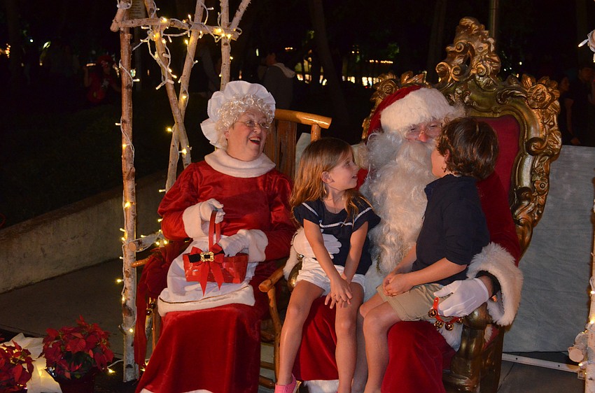 Skylar Sieving, 3, and brother, George, 5, tell Santa and Mrs. Claus what they want for Christmas.