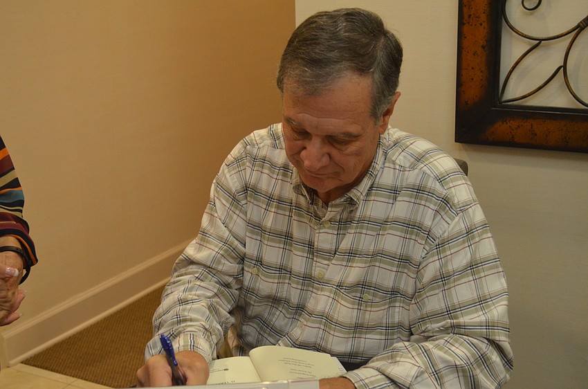 Terry Griffin autographs a copy of “Chasing Justice.”