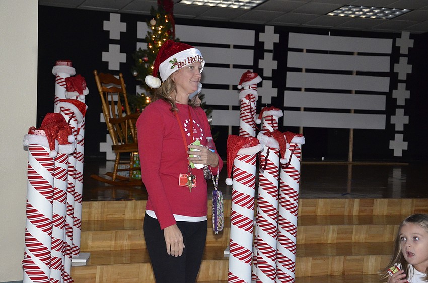PE Coach Amy Teta starts up the line to talk with Santa.