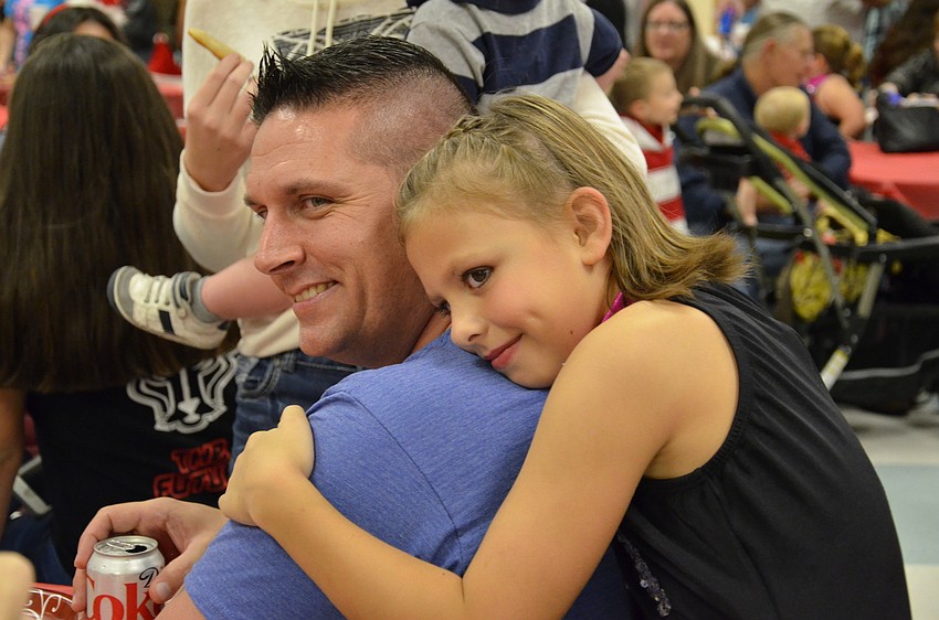 Aryanna Spainhower hugs her uncle Will Howard.