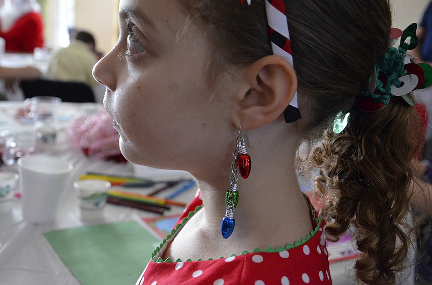 Hannah Wilk sports holiday cheer earrings.