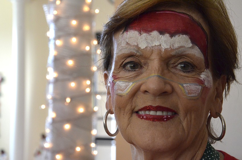 Judy Sherako painted holiday-themed designs on children's faces.