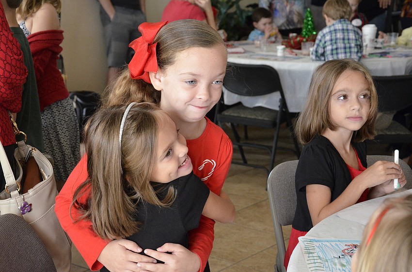 Katelyn Wolfe hugs her friend Gabriella Leo.