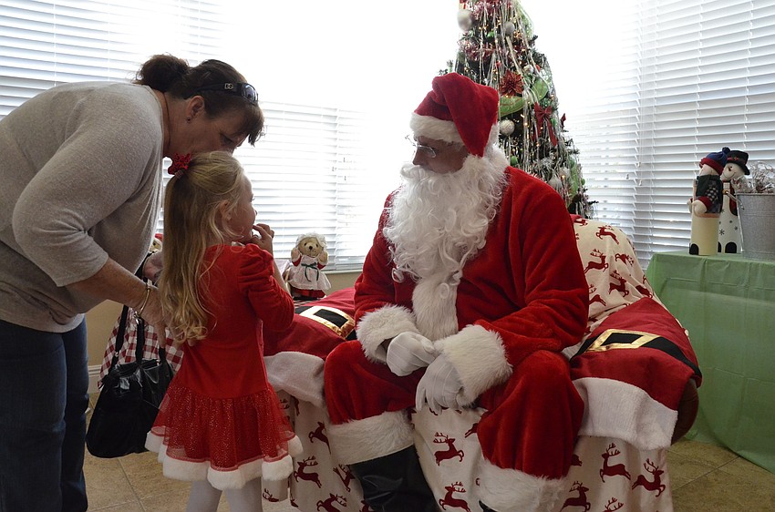 Pat Forsythe and her granddaughter, Aubree, talk with Santa.