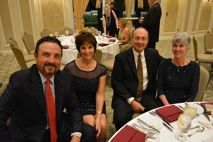 Mike Raynor, Kathy Raynor, Chip Small and Nancy Small enjoyed a moment before dinner at the Holiday Dinner Dance.