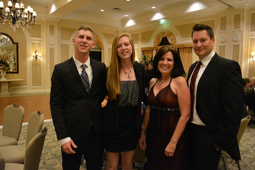 Zack Schwalbe and Holly Vincent visit with Judy Young and Jim Young at the Holiday Dinner Dance.