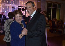 Alba and Mark Foreman wear matching smiles while dancing.