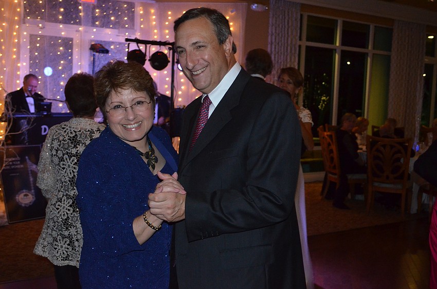 Alba and Mark Foreman wear matching smiles while dancing.