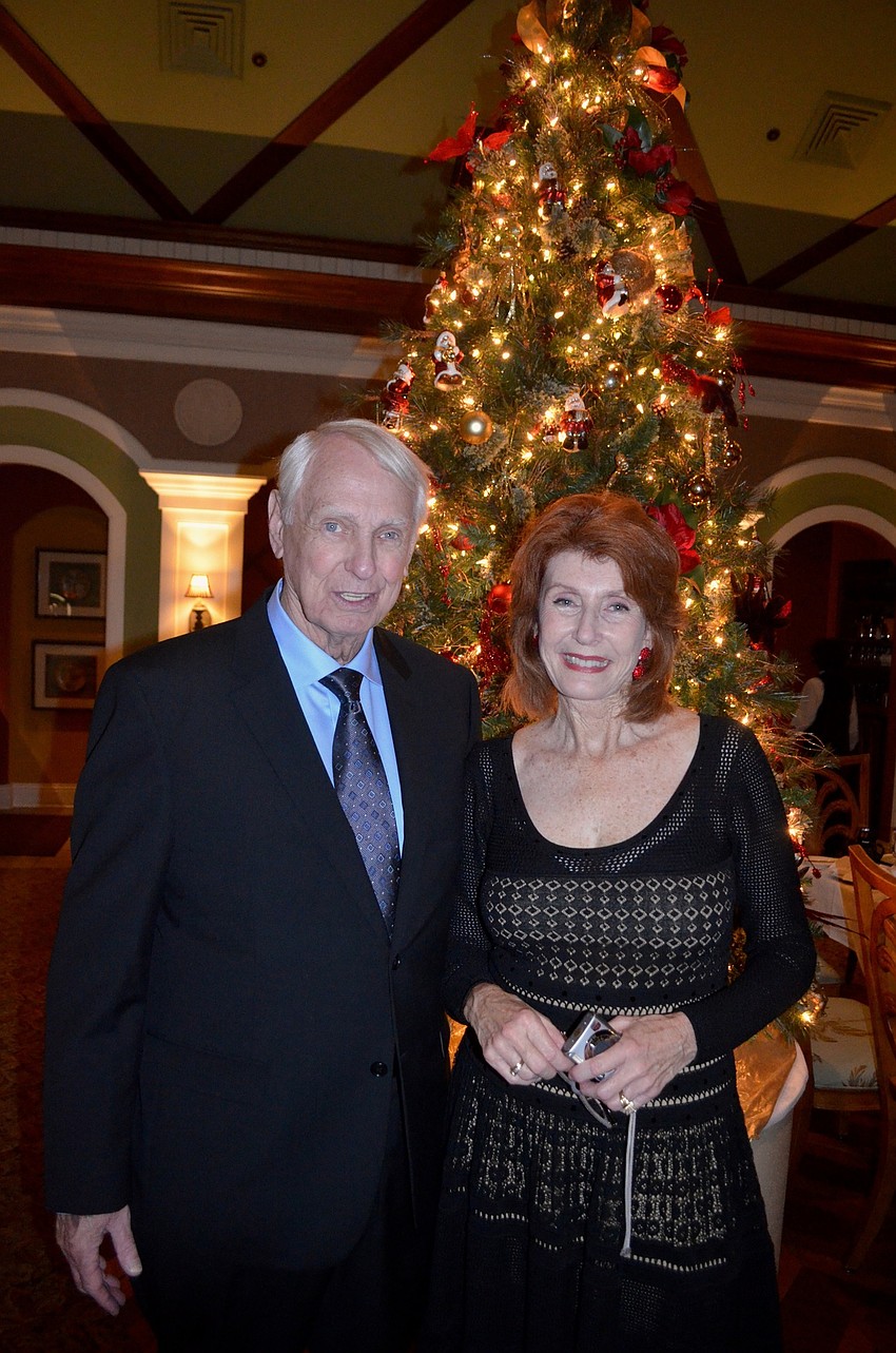 Fulton Lewis and Karen Curlin show off one of the event's centerpieces — a lighted Christmas tree.