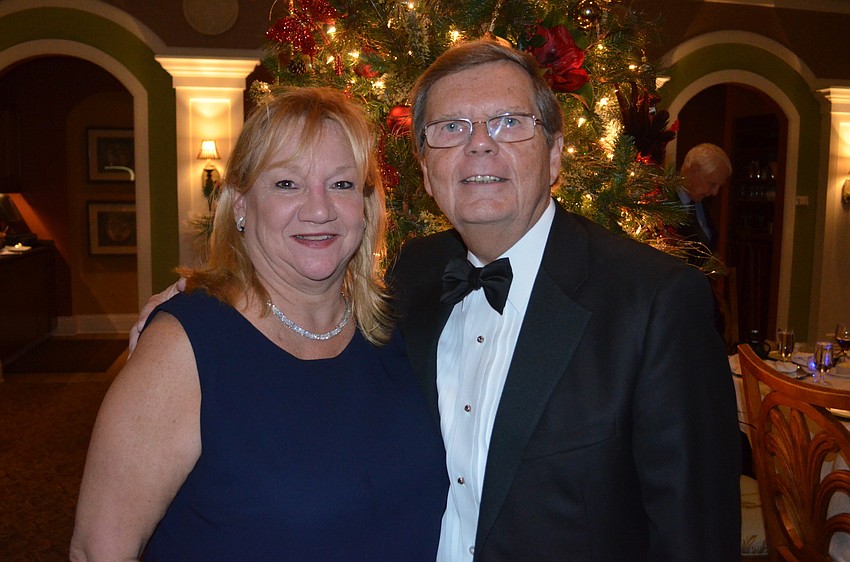 Carol and Wayne Osten cozy up near the tree.