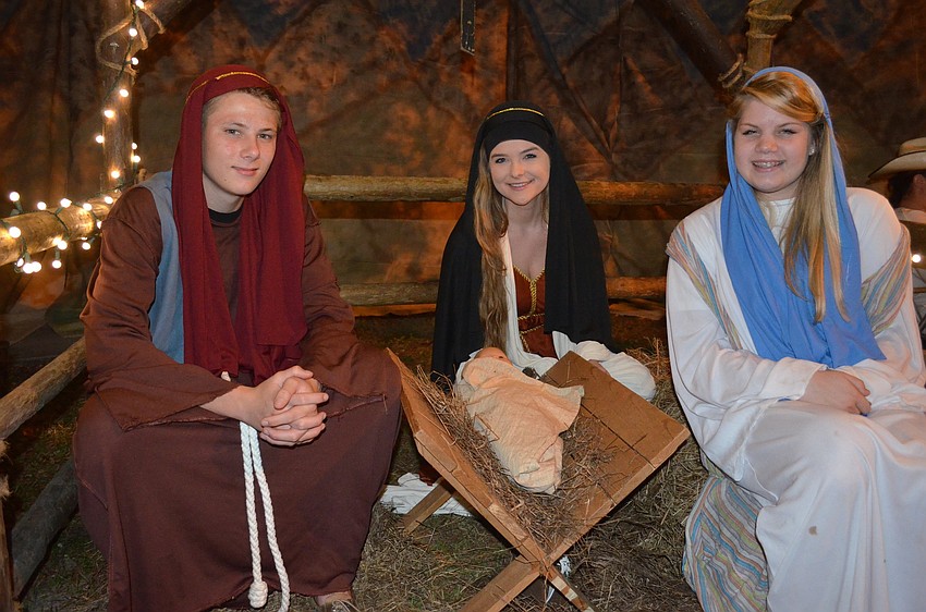 Matt Baar, Jessica Seminick and Rachel Klostermam, of Bradenton, pose inside one of many Biblical-themed props.