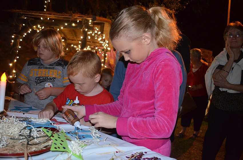 Anthony and Bella Sosso, of Bradenton, make an ornament to hang on their Christmas tree.