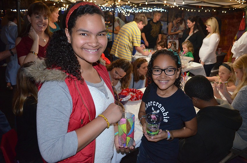 Rheann and Haela Stephens, of Bradenton, decorate glasses to bring home.
