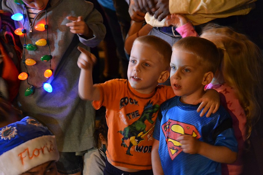 Brothers Aaron and Christopher Patterson in awe of the lights and parade floats.