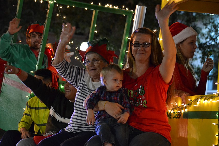 Children and families aboard the AROX Santa Claus float.