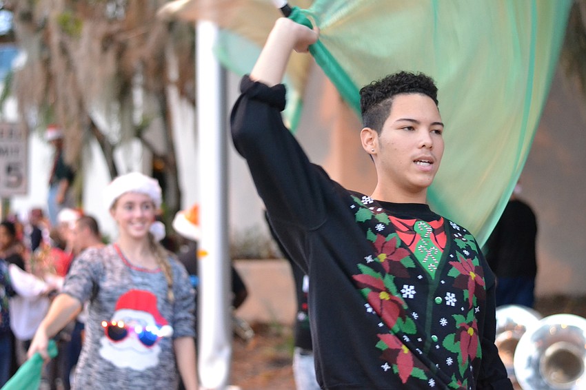 Jose Correa leads the color guard team from Booker High School in a warmup.