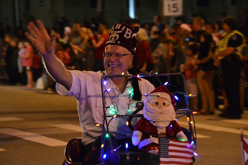 A group of members of the Sahib Shriners road along in their icon miniature cars.