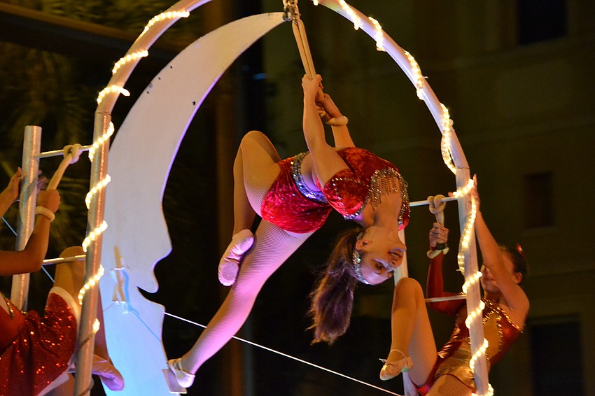 Sarah Barg from the Circus Arts Conservatory dangles in midair above the 20th annual Downtown Sarasota Holiday Parade.