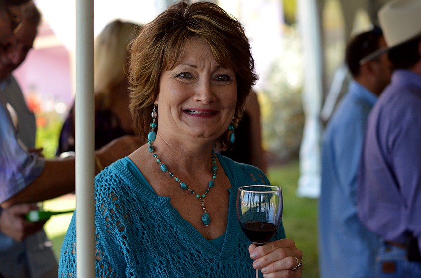 Maureen Tuncer enjoying a glass of wine at the Florida Winefest and Auction Bayfront Showcase Lunch Tasting.