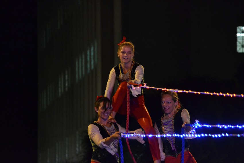 Performers from Sarasota Ski-A-Rees Water Ski Show Team towered over parade goers.