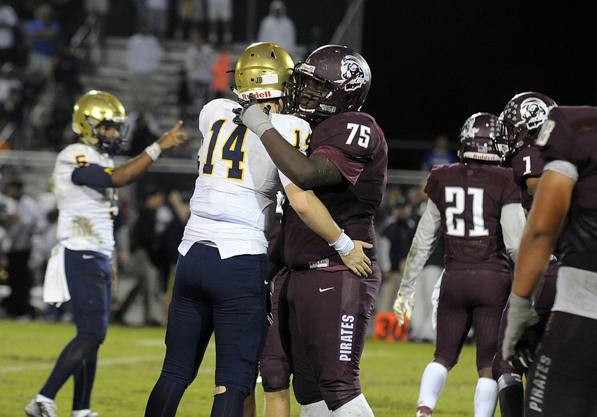 Braden River defensive lineman Deqwunn McCobb and St. Thomas Aquinas quarterback Jake Allen meet in the middle of the field as the final seconds tick off of the clock.