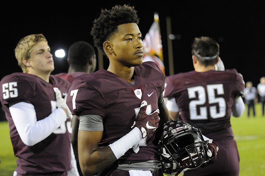 Braden River junior defensive back Demetrius Lawson listens to the National Anthem before the start of the Pirates Class 7A state semifinal Dec. 4.