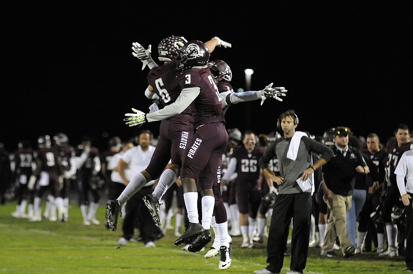 Travis Williams, Jaylin Austin and Juwaan Jenkins celebrate following Williams' 7-yard touchdown catch on the Pirates opening possession.