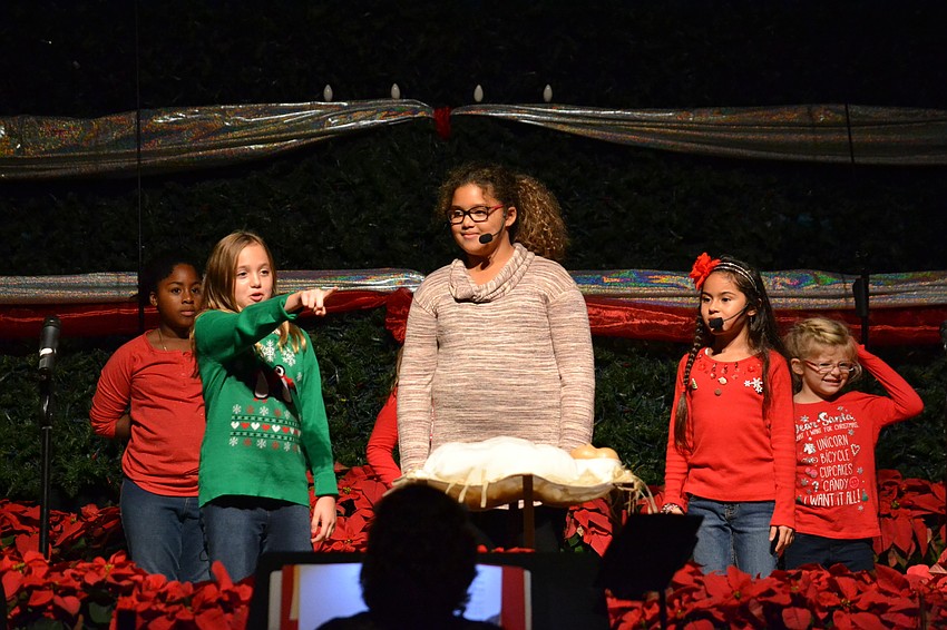 Members of the Make Some Christmas Noise Children's Choir open the performance.