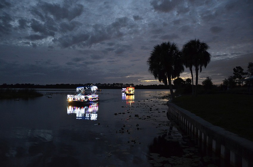 The four boats in the parade cruised past Jiggs Landing before heading east to Linger Lodge.