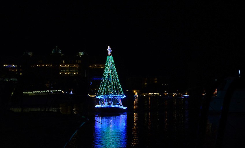 A boat decorated as a Christmas tree makes its way down the bay for the Holiday Boat Parade of Lights.