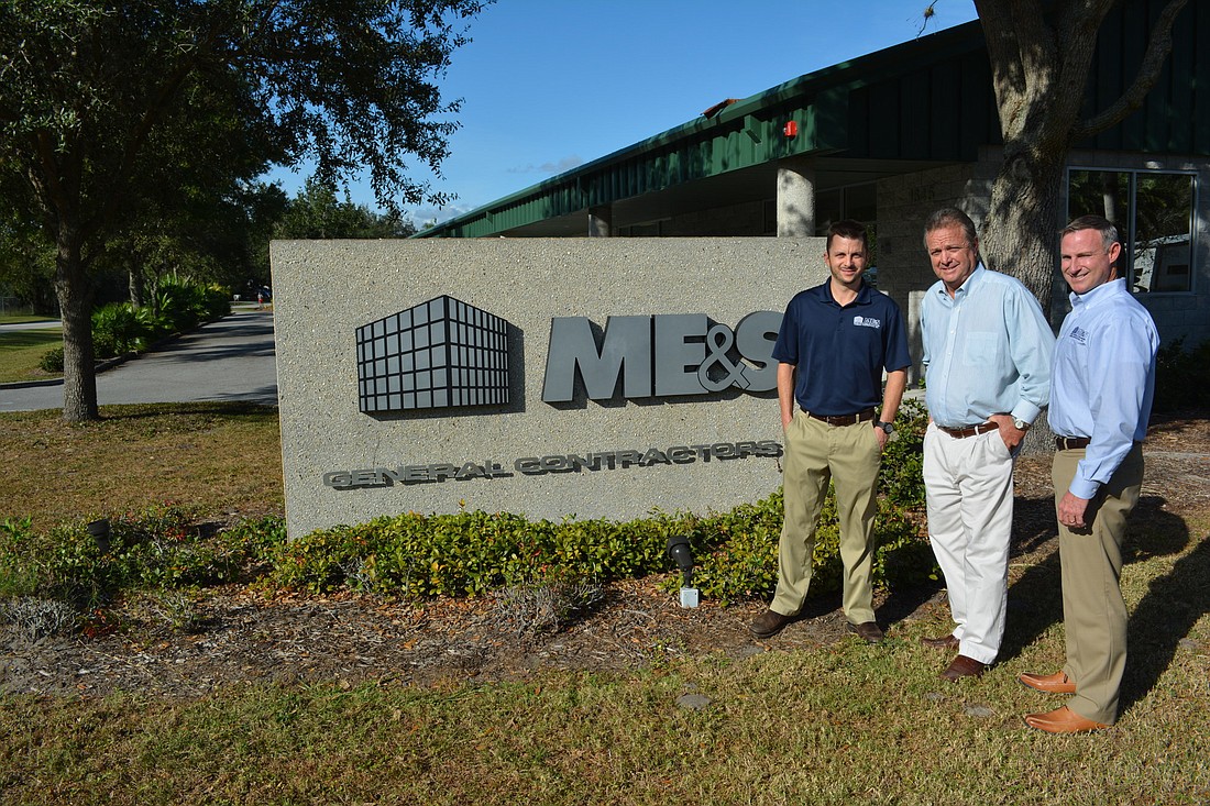 Ryan McIntyre, John McIntyre and Mark Freeman pose outside the company's office in Sarasota.