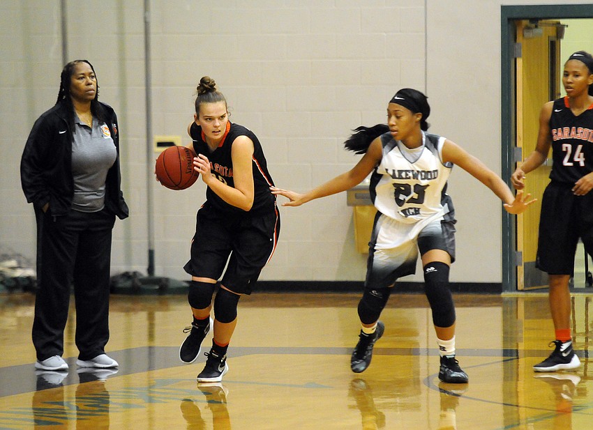 Sarasota junior Madison Pack dribbles around Lakewood Ranch's LaDazhia Williams.