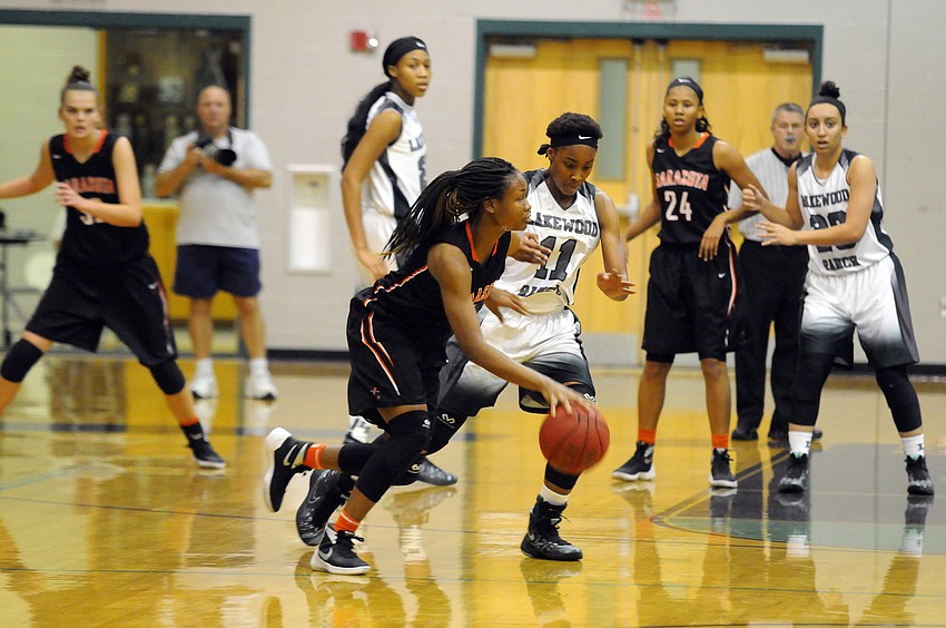 Sarasota sophomore Imani Jones dribbles along the arc in search of a lane.